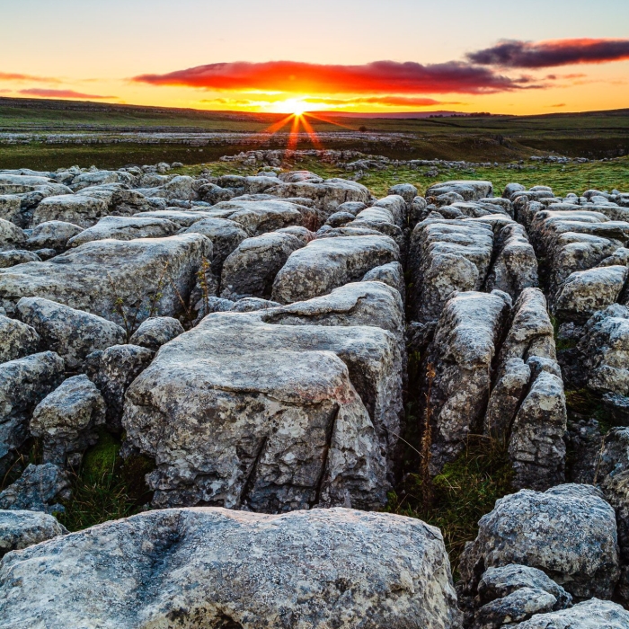 Sunrise over limestone pavement at Malham Lings, Yorkshire Dales, England. EL030