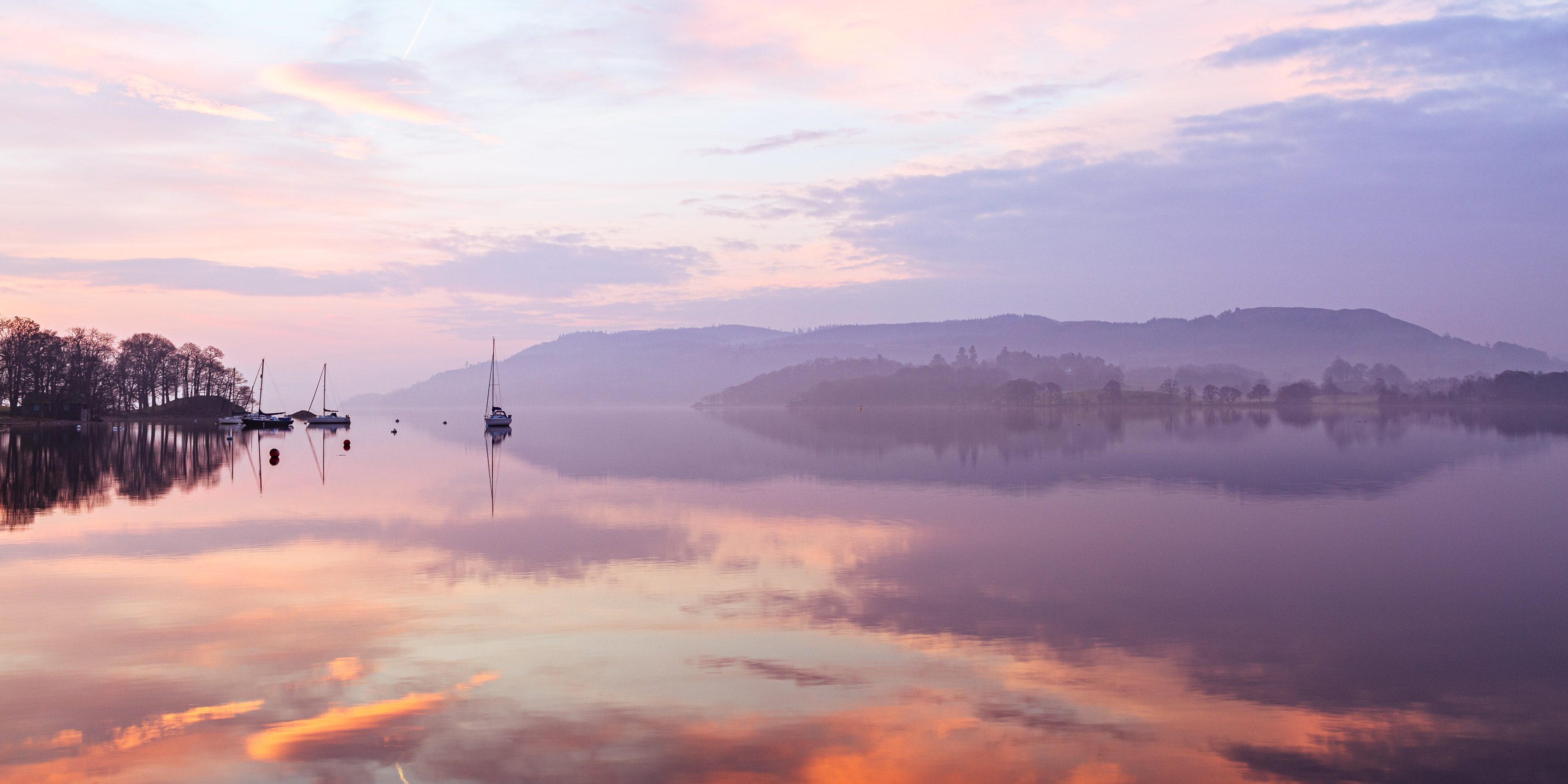 Dawn reflections on Windermere, from Waterhead pier, Cumbria, England. EL028