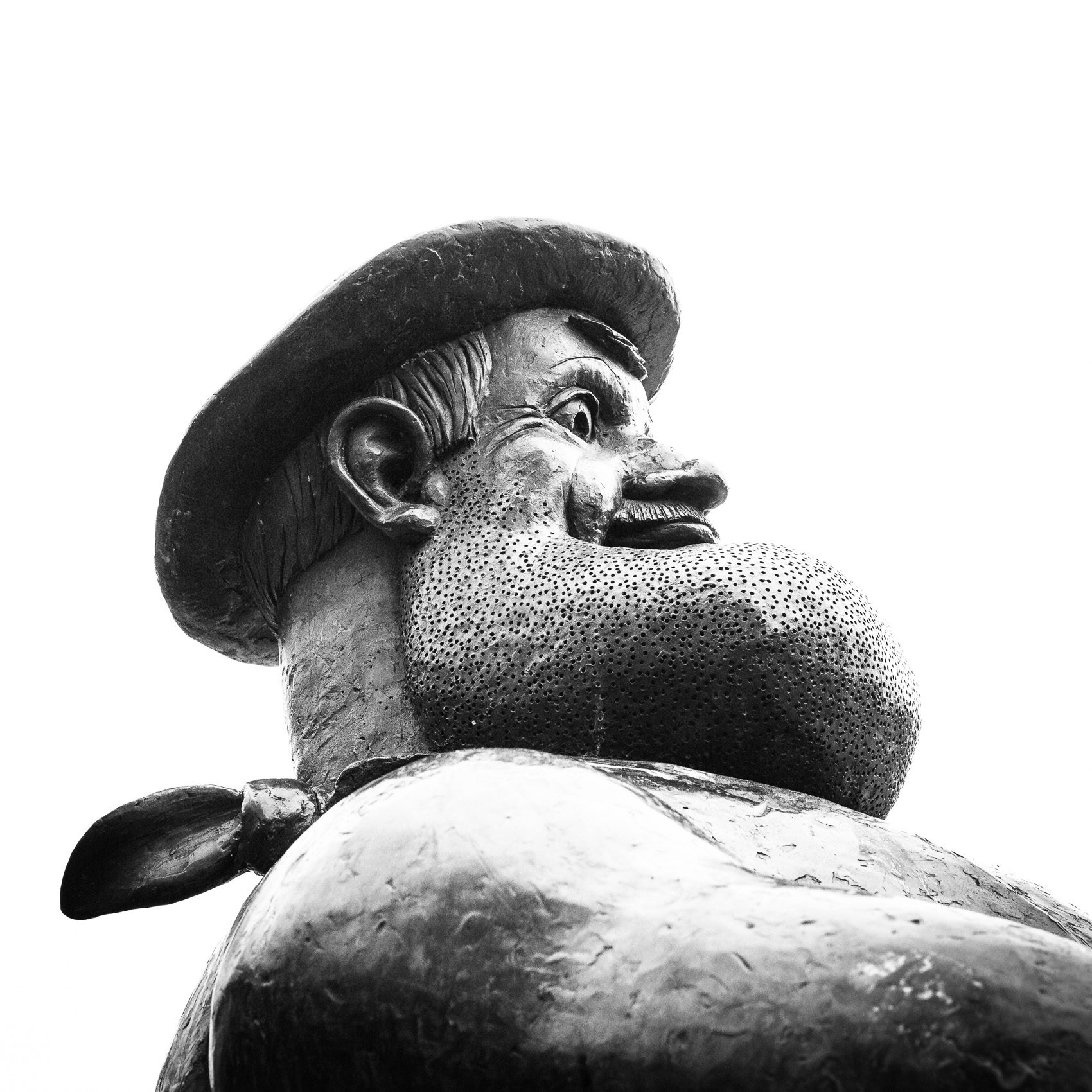 Monochrome (black and white) Desperate Dan statue in Dundee High Street, Scotland. DD016