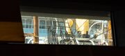 View of the RRS Discovery through a rectangular window of the V&A building in Dundee, Scotland.