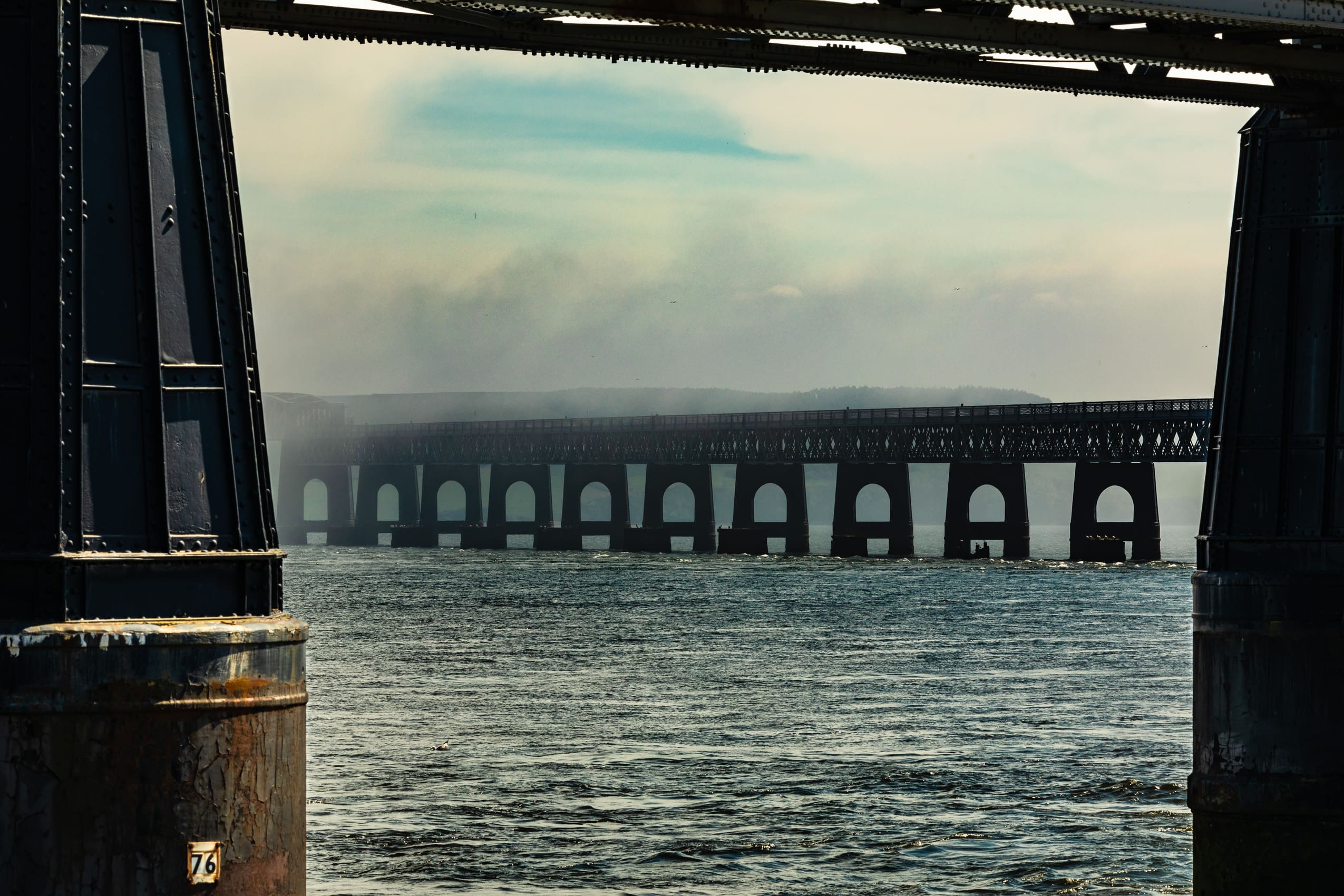 The central arches of the Tay Rail Bridge framed by pillars at the Dundee end, Scotland. DD081