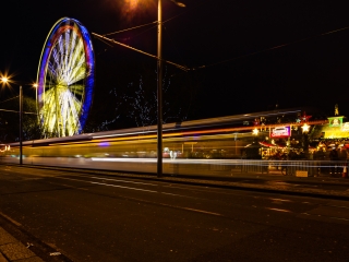 Light trails and a giant Ferris Wheel in Princes Street, Edinburgh, Scotland. EH012