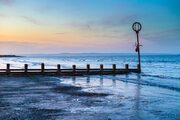 Groyne and marker post at Portobello beach, Edinburgh, Scotland, United Kingdom. EH035