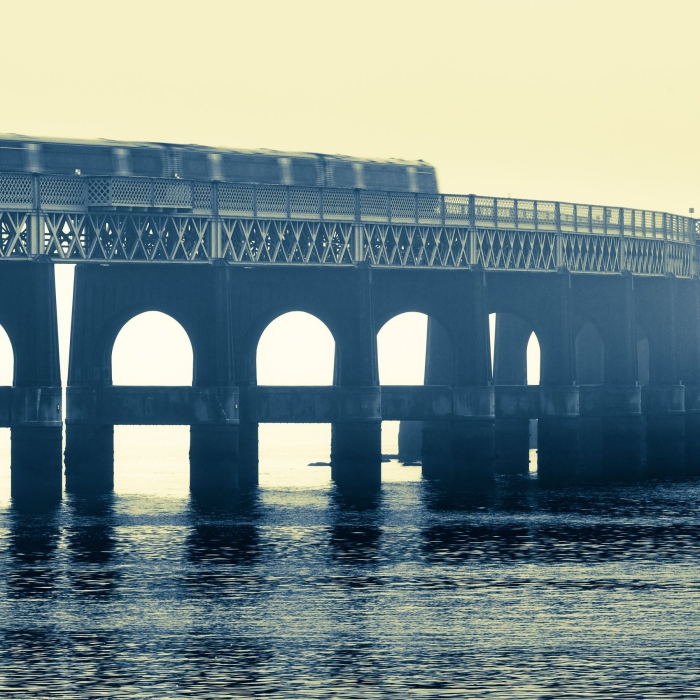 Duotone image of the Tay Railway Bridge as a train passes over, Dundee, Scotland. DD079