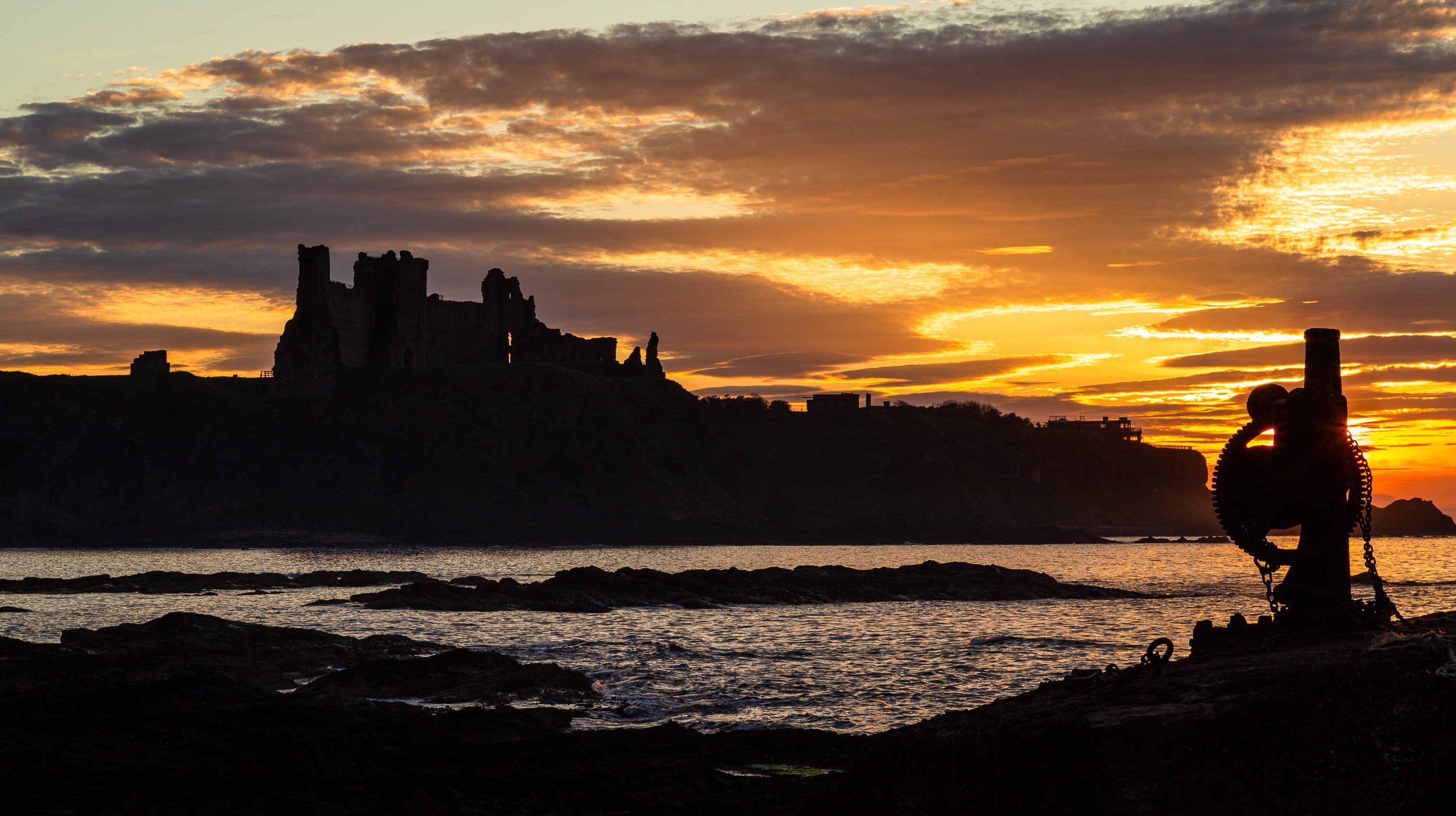 Tantallon Castle silhouetted against the sunset from Seacliff, East Lothian, Scotland. LN003