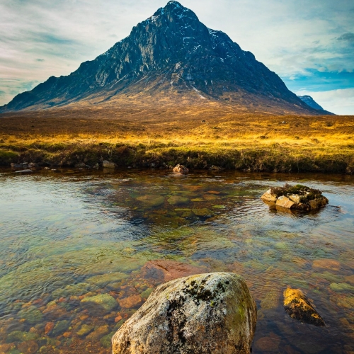 Buachaille Etive Mor casting a shadow in the River Coupall, Rannoch Moor, Scotland.