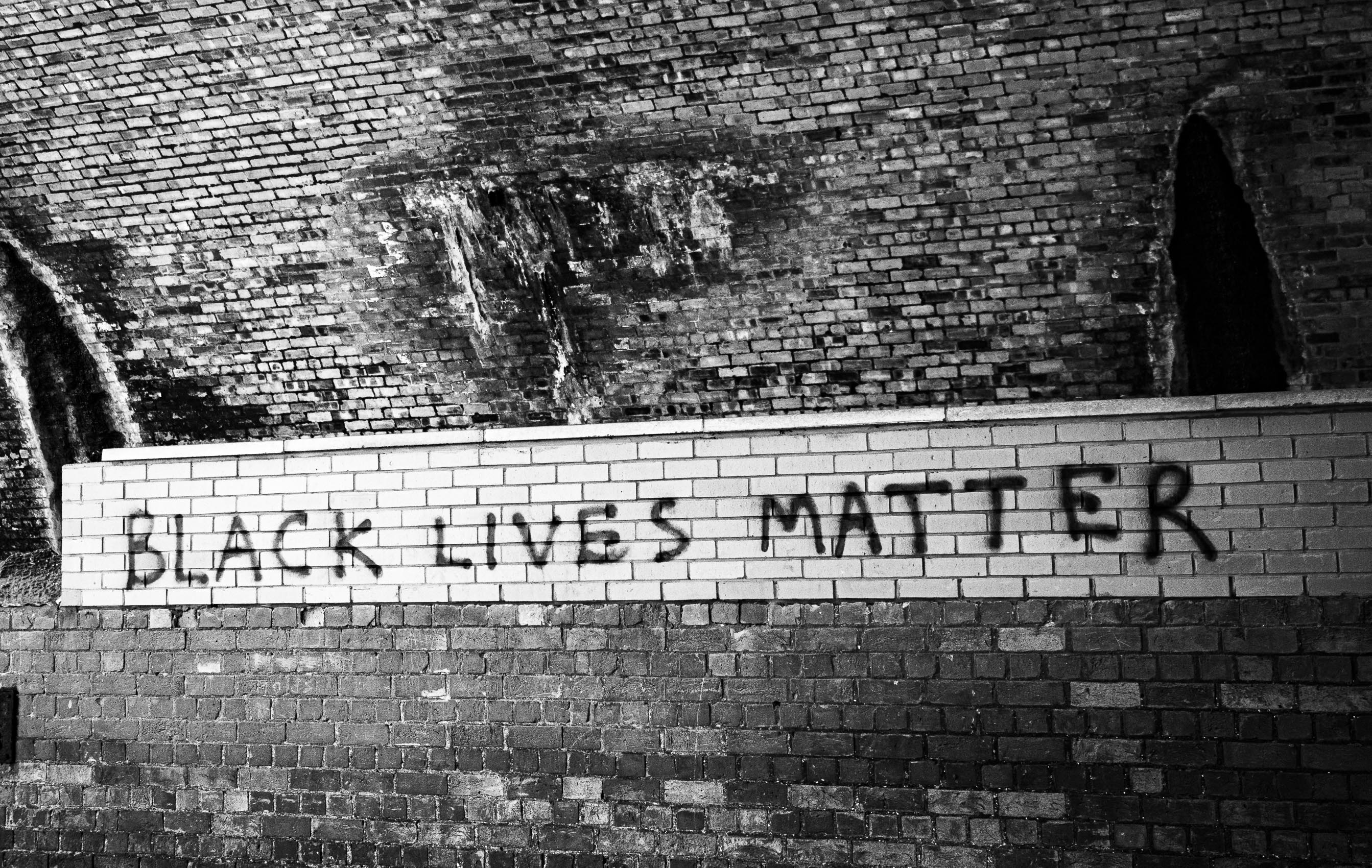 Slogan painted under the Tay Rail Bridge, Wormit, Fife, Scotland.