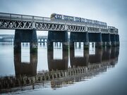 Train passsing over the Tay Railway Bridge in mist Dundee, Scotland.