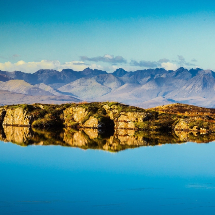 The Cuillins of Skye viewed from a lochan near the Bealach na Ba, Applecross, Scotland. AP014