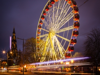 Light trails and a a giant Ferris Wheel in Princes Street, Edinburgh, Scotland. EH010