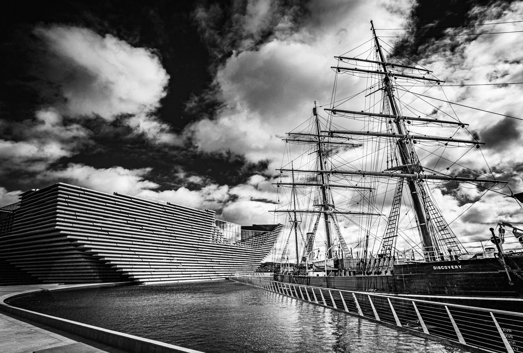 Monochrome (black and white) image of RRS Discovery and the V&A Dundee, Dundee, Scotland. DD023