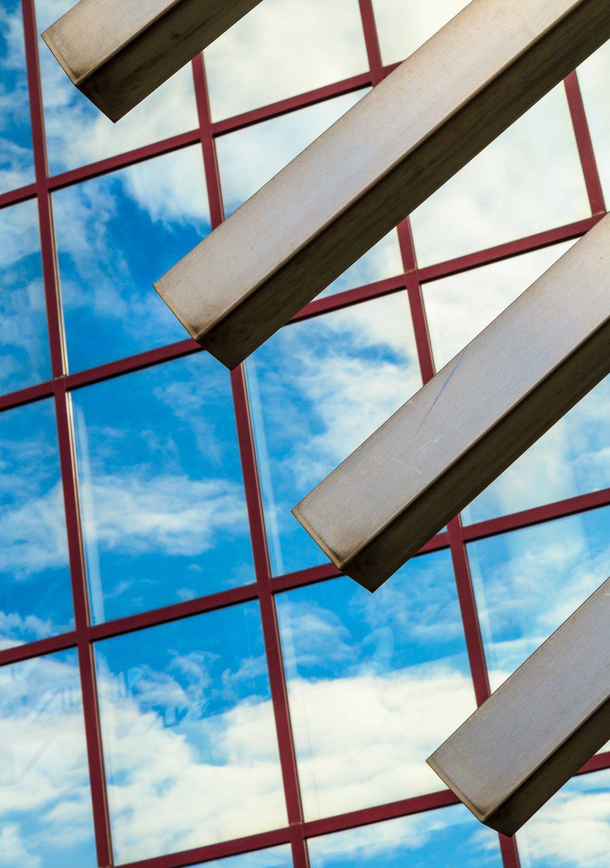 Reflection of the sky in the windows of the DZ Bank building, seen through thre bars of the metal archway in the Platz der Republic, Frankfurt am Main, Hesse, Germany. FF019