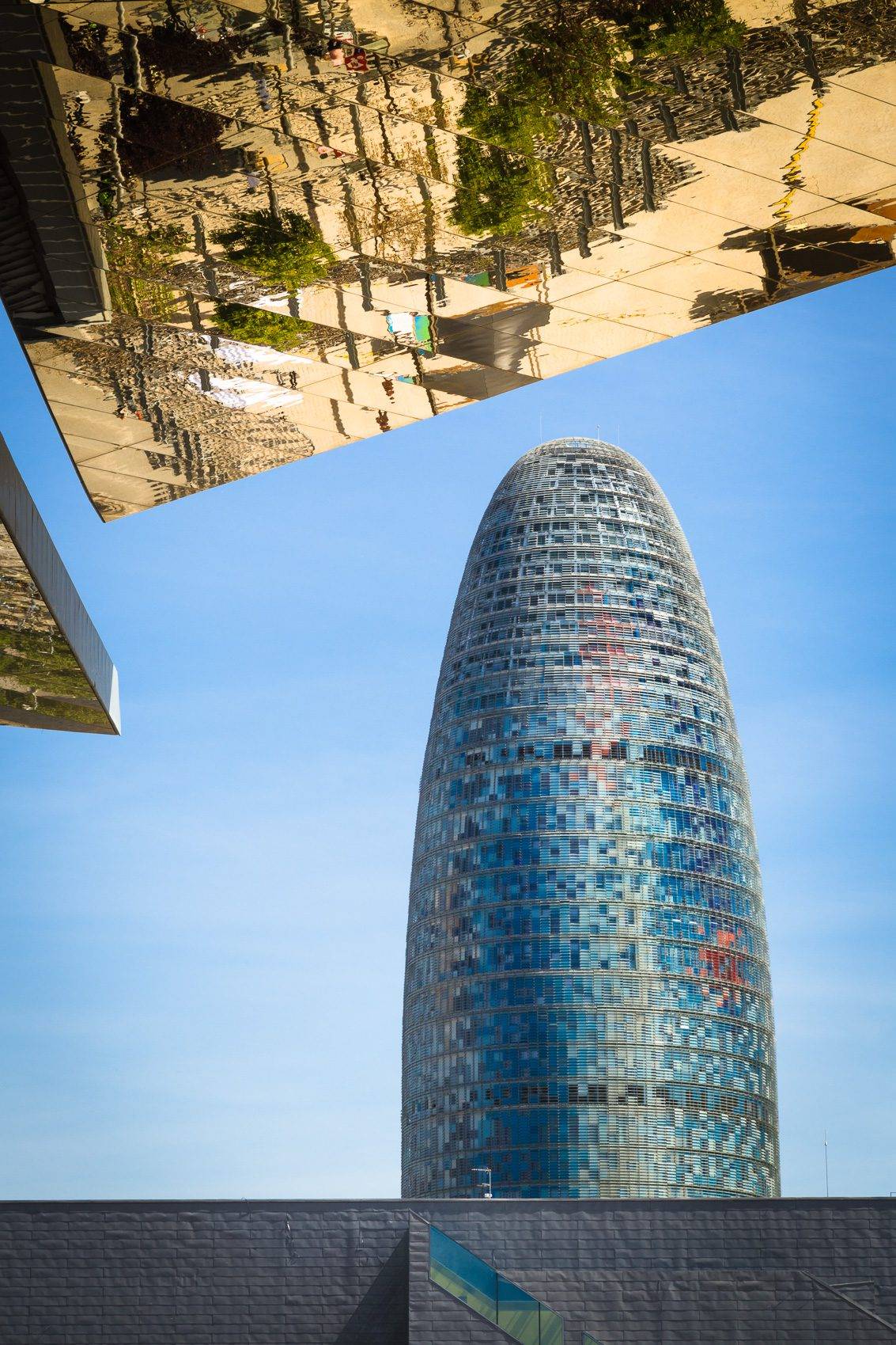 Reflection in mirrored roof of the Encants Vells Flea Market, with the Agbar Tower in the background, Barcelona Spain. BC016